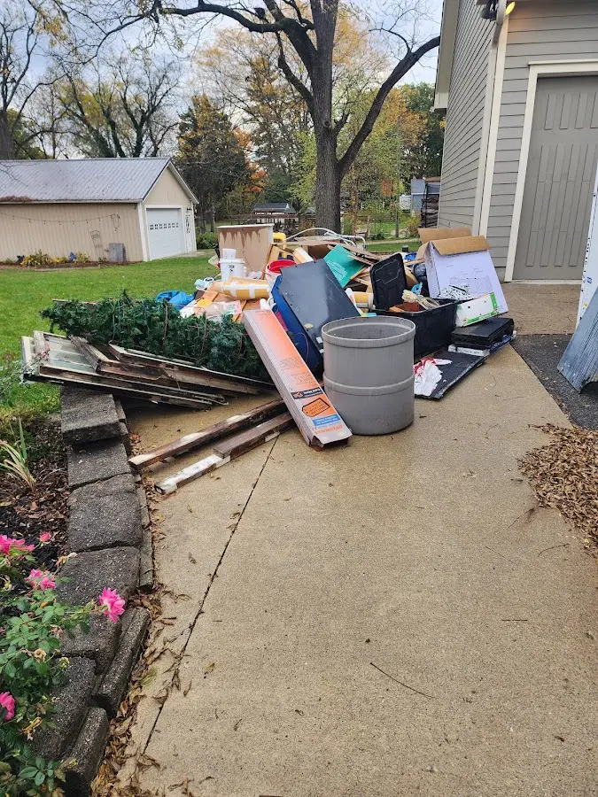 Dumpster being loaded with debris for Estate Cleanout Dumpster Rental in Owens Cross Roads